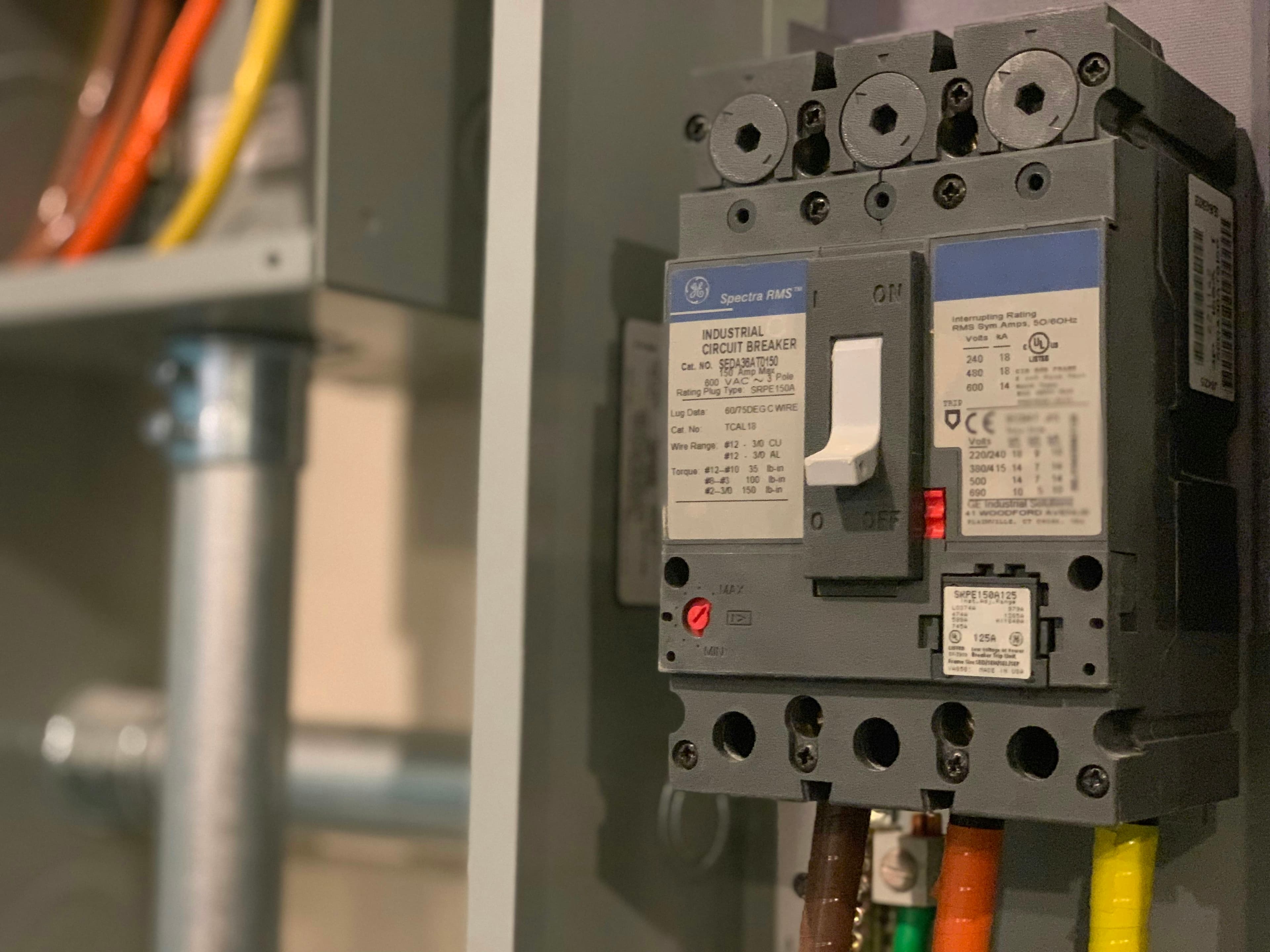 Close-up of an electrical panel circuit breaker and wiring